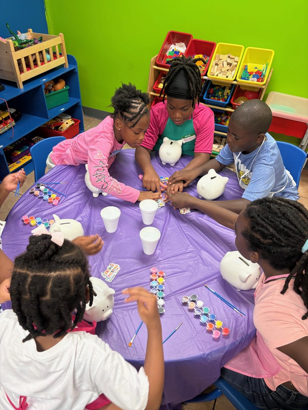 Children decorating their piggy banks at a Unique Little Savers session